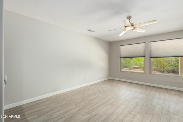 empty room with light hardwood / wood-style flooring and ceiling fan