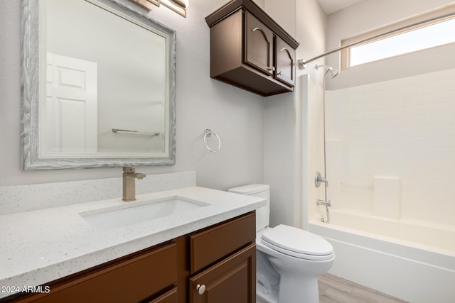 full bathroom featuring vanity, bathtub / shower combination, and toilet