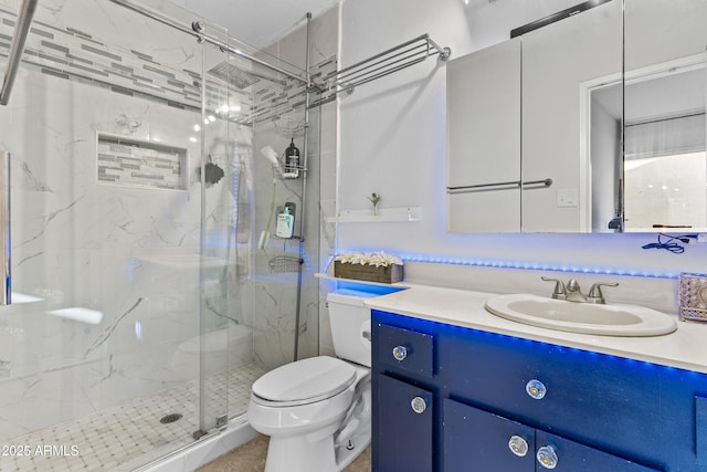 2313 N 87th Way, Scottsdale, AZ 85257 - full bathroom featuring toilet, vanity, and a marble finish shower