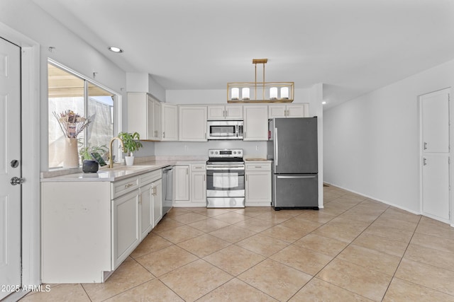 2313 N 87th Way, Scottsdale, AZ 85257 - kitchen featuring stainless steel appliances, a sink, light tile patterned floors, light countertops, and recessed lighting
