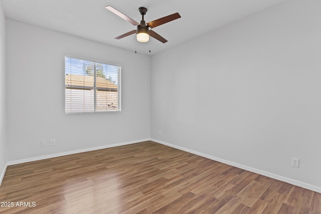 2313 N 87th Way, Scottsdale, AZ 85257 - empty room featuring wood finished floors, a ceiling fan, and baseboards