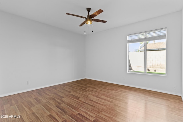 2313 N 87th Way, Scottsdale, AZ 85257 - spare room with wood finished floors, ceiling fan, and baseboards