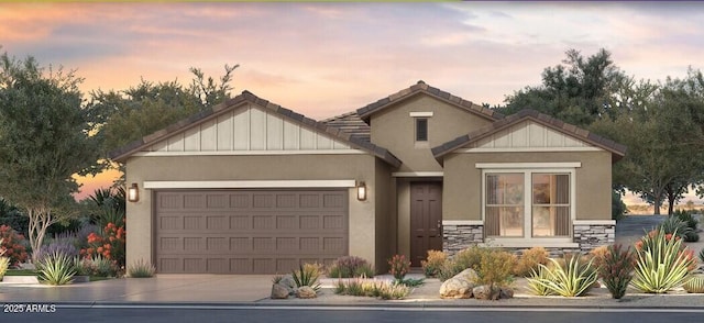 traditional-style home featuring an attached garage, stucco siding, stone siding, and driveway