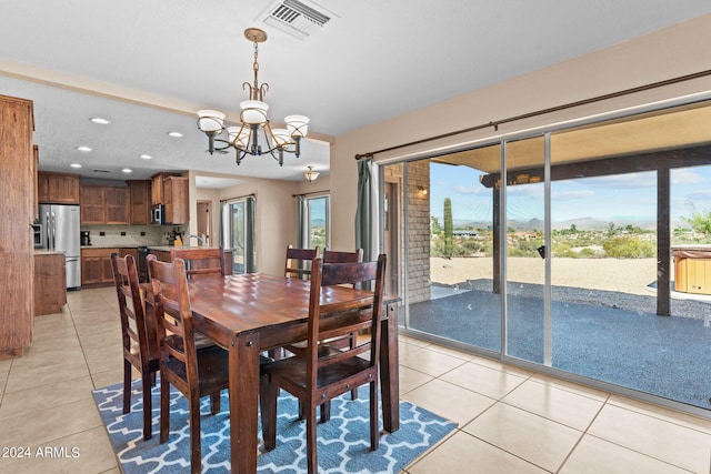 dining room featuring light tile patterned floors and a chandelier