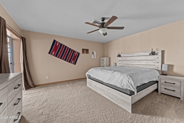 carpeted bedroom featuring a textured ceiling and ceiling fan