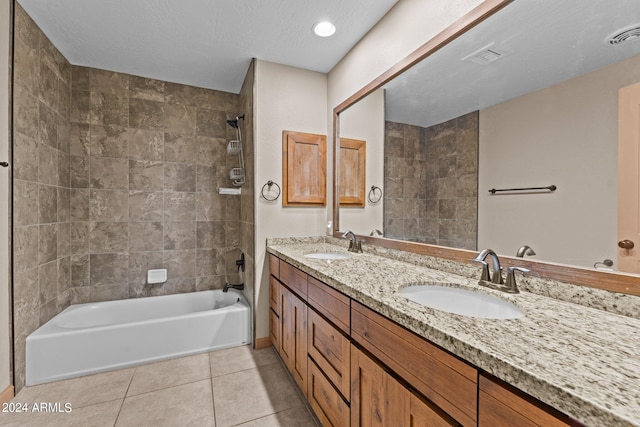 bathroom featuring vanity, tiled shower / bath combo, a textured ceiling, and tile patterned floors