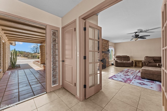 interior space with a textured ceiling and ceiling fan