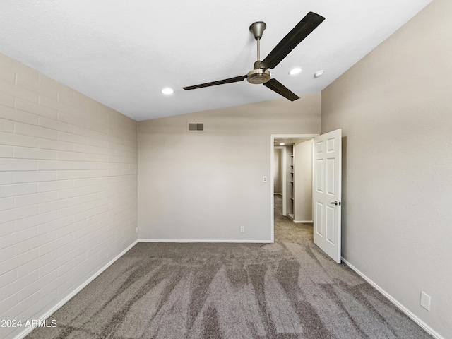 carpeted empty room with ceiling fan and vaulted ceiling