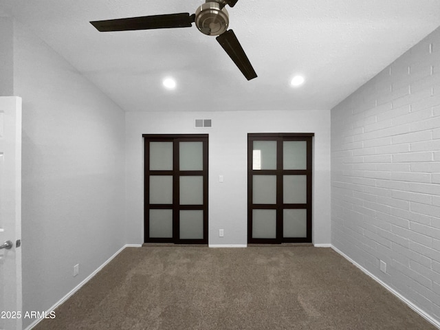 4925 N 73rd St Unit 4, Scottsdale, AZ 85251 - spare room with ceiling fan, carpet floors, baseboards, brick wall, and recessed lighting