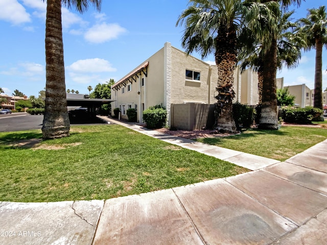 view of property exterior featuring a lawn and a carport