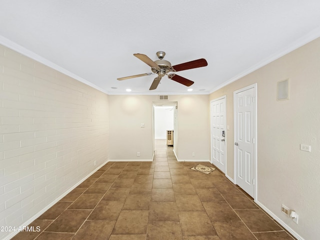 unfurnished room with ceiling fan and crown molding