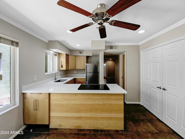 kitchen featuring stainless steel refrigerator, kitchen peninsula, black electric stovetop, and light brown cabinets