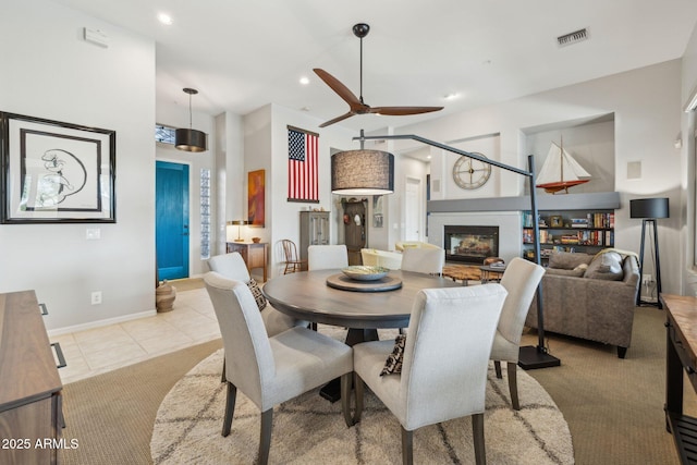 dining space with light tile patterned floors and ceiling fan