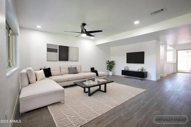 living room with dark wood-style flooring, recessed lighting, visible vents, ceiling fan, and baseboards