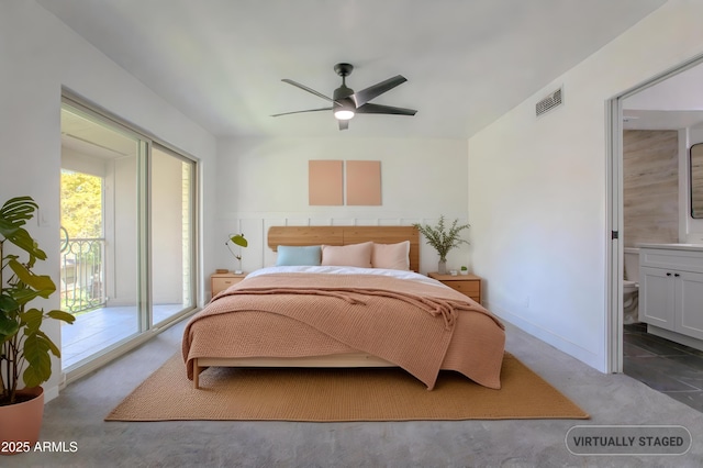 carpeted bedroom featuring access to outside, ensuite bath, visible vents, and a ceiling fan