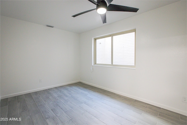 unfurnished room featuring visible vents, baseboards, ceiling fan, and wood finished floors