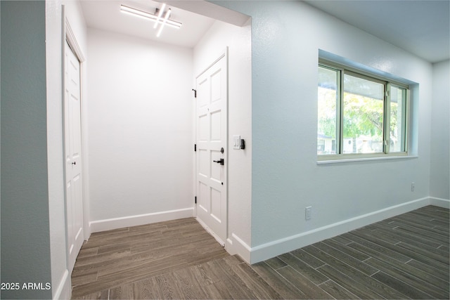 entryway with dark wood-type flooring and baseboards