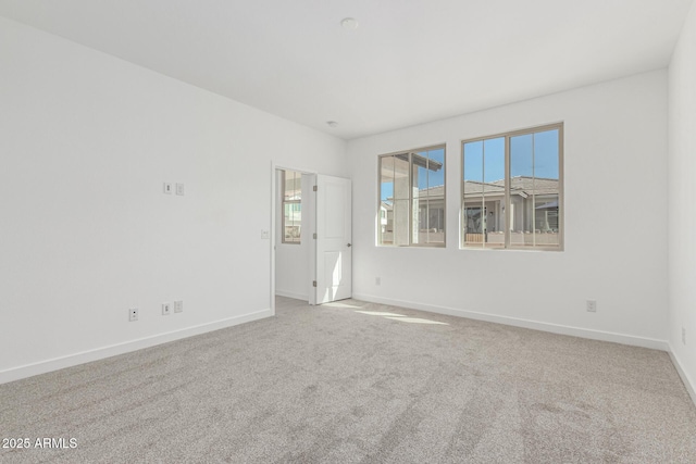 carpeted empty room with baseboards