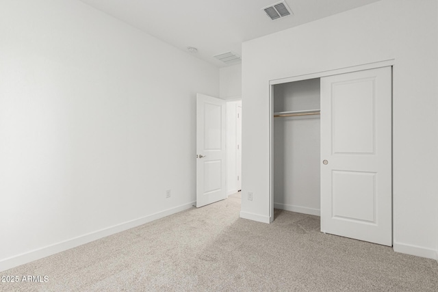 unfurnished bedroom with light carpet, baseboards, visible vents, and a closet