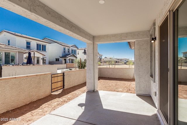 view of patio with a residential view and a fenced backyard