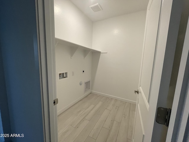 clothes washing area with laundry area, light wood finished floors, visible vents, hookup for an electric dryer, and washer hookup