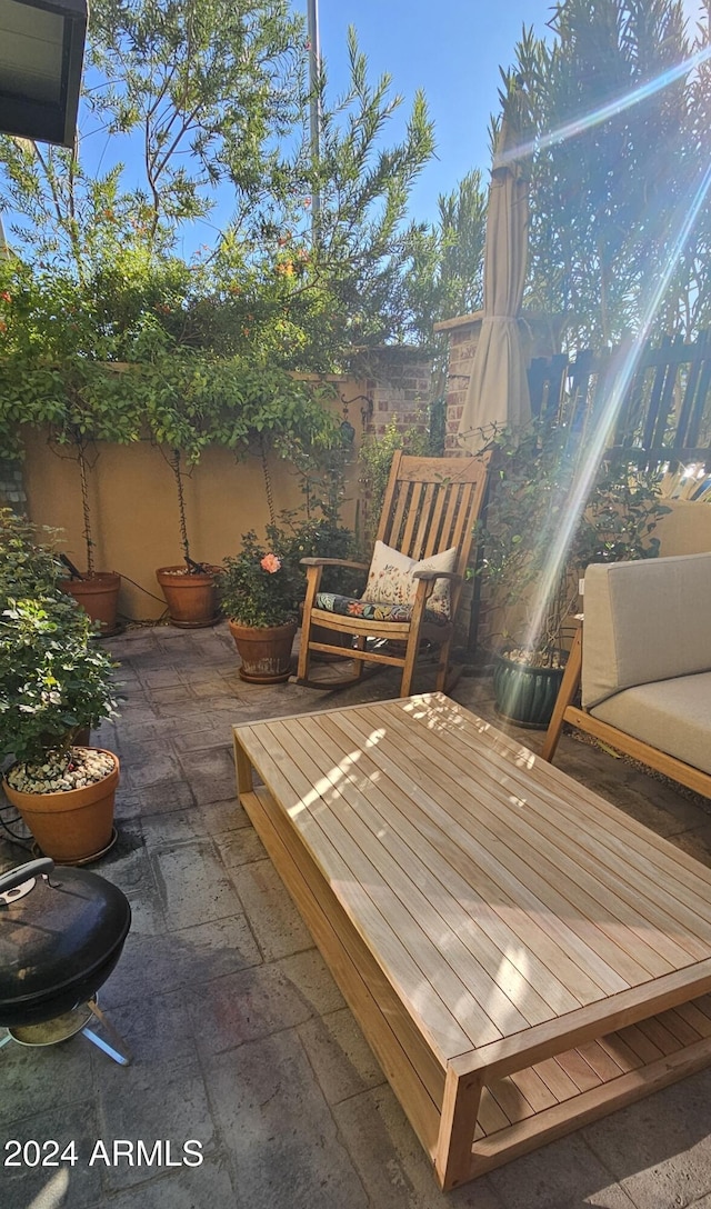 wooden terrace with a patio area