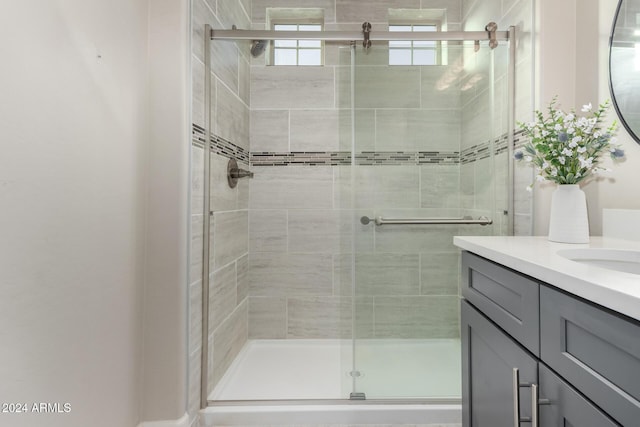 bathroom with vanity and a shower with shower door