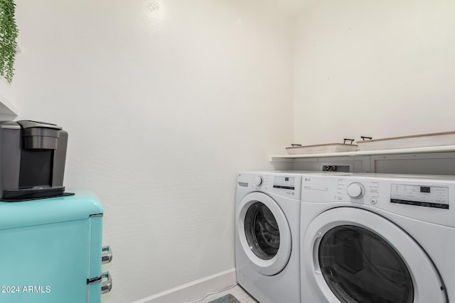 clothes washing area with washing machine and clothes dryer and light tile patterned floors