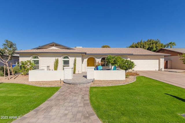 ranch-style house with a garage and a front yard