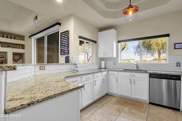 kitchen with white cabinetry, sink, backsplash, stainless steel dishwasher, and light stone countertops