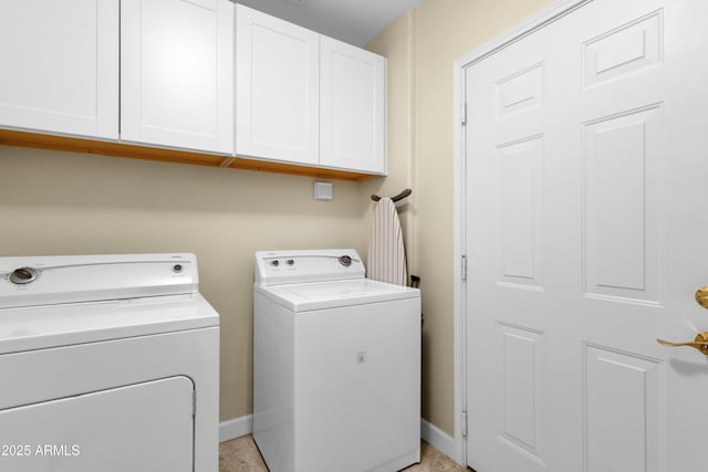 washroom featuring cabinets and washer and dryer