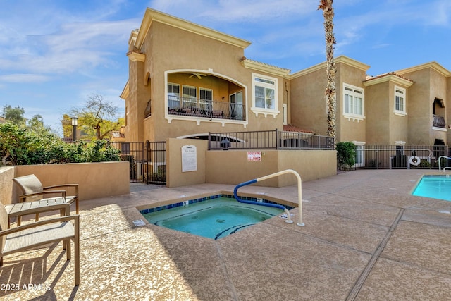 exterior space featuring a hot tub, a patio, and ceiling fan