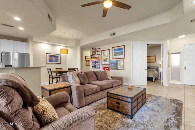 living room featuring ceiling fan and light tile patterned floors