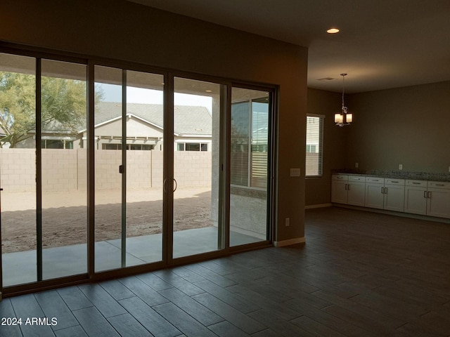 entryway featuring dark hardwood / wood-style floors and a notable chandelier