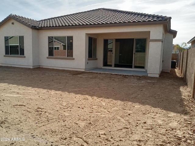 back of house featuring central AC unit