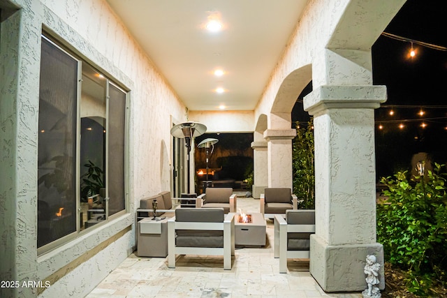 view of patio / terrace with an outdoor living space with a fire pit