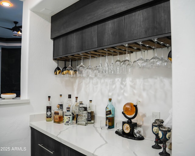 bar with ceiling fan and a dry bar