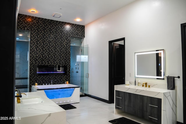 full bath with a shower stall, a freestanding bath, and vanity