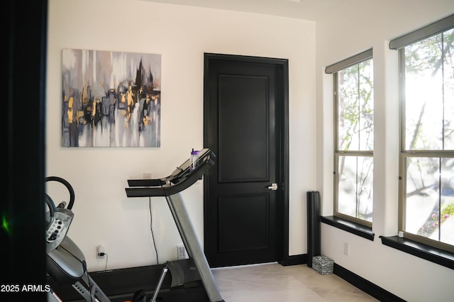 workout area featuring baseboards