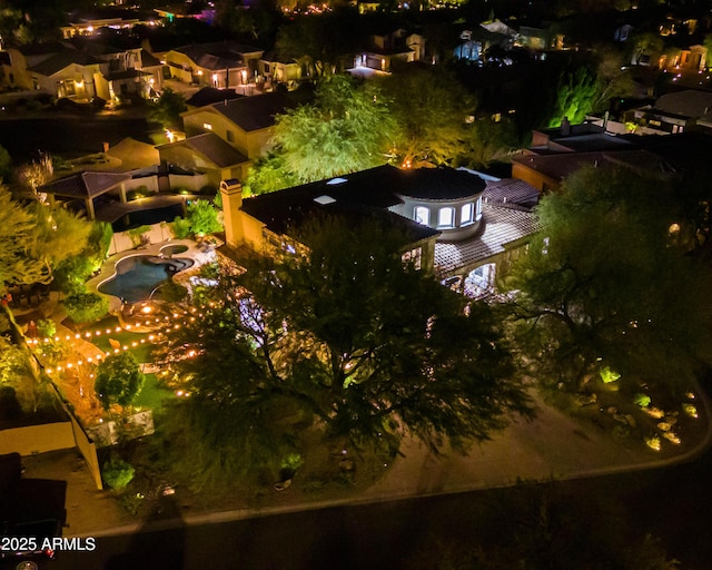 aerial view at night featuring a residential view