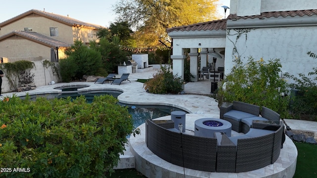 view of yard with a fire pit, a patio, fence, and an in ground hot tub