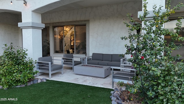 view of patio / terrace with an outdoor living space with a fire pit