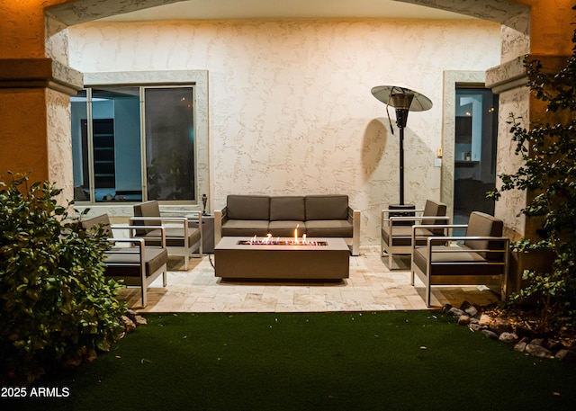 view of patio / terrace with an outdoor living space with a fire pit