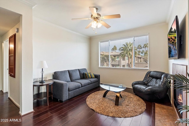 living room featuring ornamental molding, ceiling fan, and dark hardwood / wood-style flooring