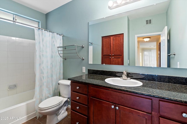 bathroom featuring toilet, vanity, visible vents, tile patterned floors, and shower / bath combo with shower curtain