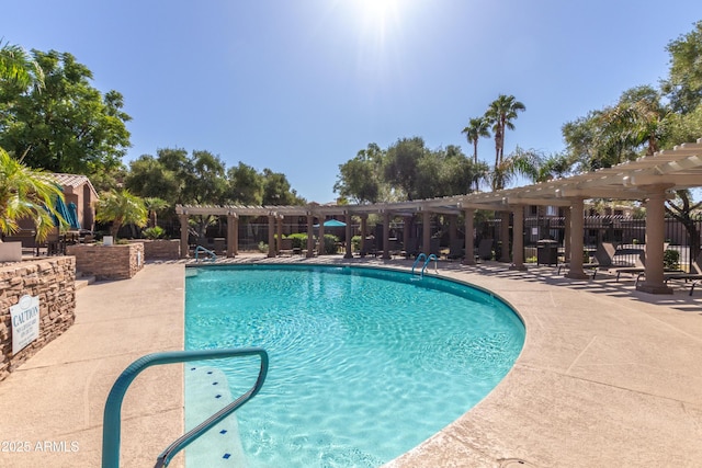 community pool featuring fence and a pergola