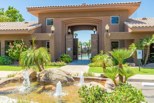 property entrance with a tiled roof and stucco siding