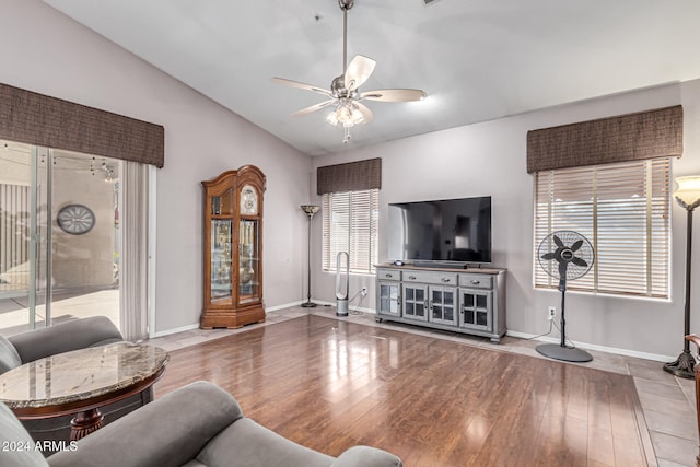 living room with ceiling fan, lofted ceiling, and light hardwood / wood-style flooring