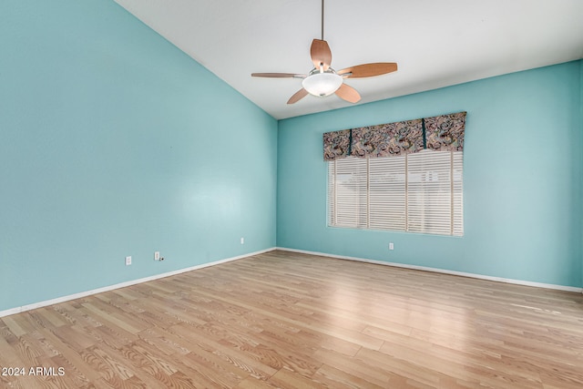 spare room featuring light wood-type flooring, ceiling fan, and lofted ceiling