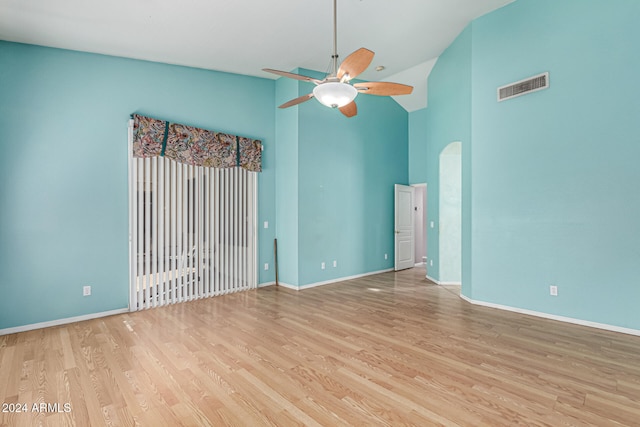 unfurnished room featuring ceiling fan, light wood-type flooring, and high vaulted ceiling